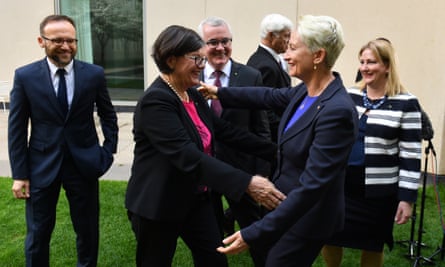 Independent member for Indi Cathy McGowan (second from left) and independent member for Wentworth Kerryn Phelps hug as Greens Member for Melbourne Adam Bandt (left), independent member for Denison Andrew Wilkie, Bob Katter and Centre Alliance member for Mayo Rebekha Sharkie look on.