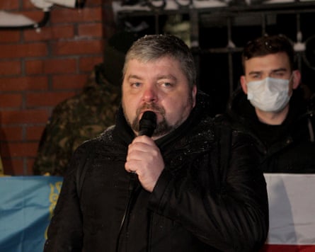 Maksym Butkevych speaking into a microphone outside