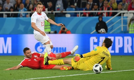 Xherdan Shaqiri squeezes the ball past Vladimir Stojkovic to score a late winner for Switzerland.