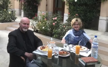 Peter and Barbie Reynolds eating at an outdoor table in a courtyard
