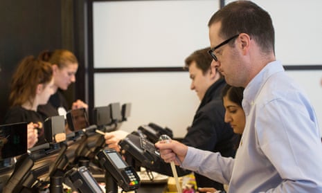 Customers pay for food on a Verifone card machine