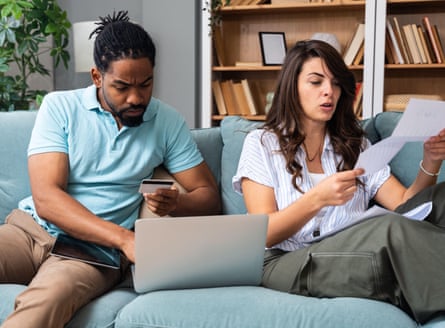 couple reviewing household bills making online payment at home woman check document while man enters debit card details on laptop budgeting t3D7DEWG couple reviewing household bills making online payment at home woman check document while man enters debit card details on laptop budgeting t