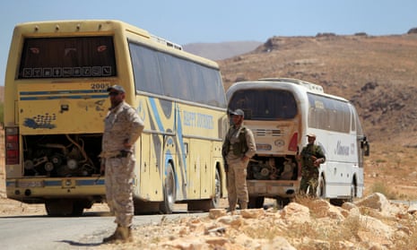 Hezbollah fighters stand near buses in Jroud Arsal, near Syria-Lebanon border. 