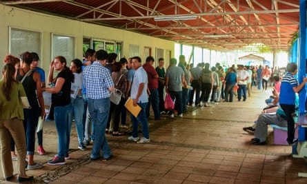 Nicaraguans queue at a migration office in Managua, to obtain their passports on Wednesday. Many Nicaraguans are seeking to migrate to Central American border countries, escaping a two-month long uprising.