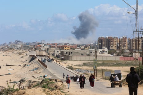 Smoke rises after an Israeli strike as Palestinians fleeing north Gaza due to Israel’s military offensive move southward on Friday.