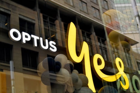 Signage is seen in the window of an Optus store in Sydney