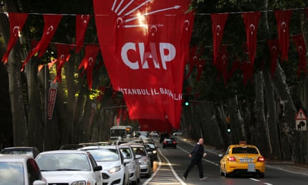 A man crosses a street under the flag of Turkey’s main opposition Republican People’s party (CHP), in Istanbul.