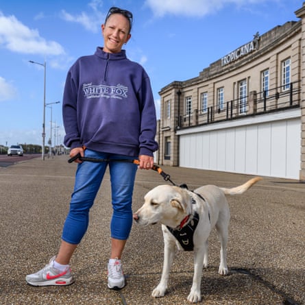 Adele Stitch outside the Tropicana with a golden labrador
