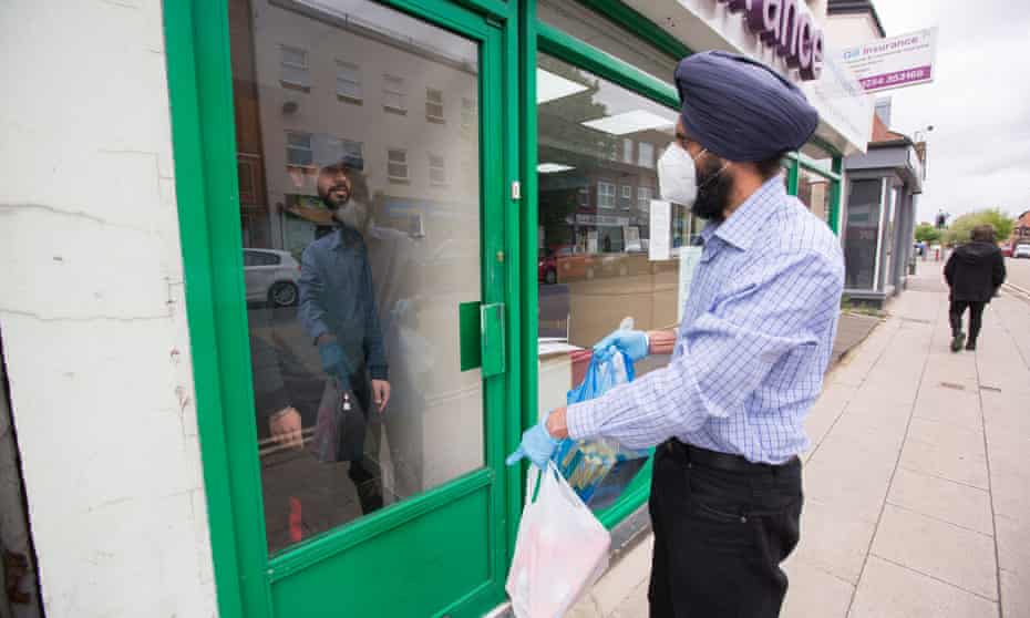 Charan Sekhon of the Seva Trust, based in Bedford, provides a student with a food parcel