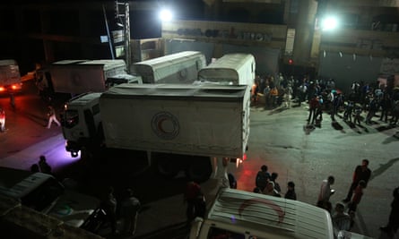 Aid workers unload food and other supplies in Madaya