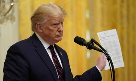 Donald Trump holds up a news story from the New York Times during a press conference with the Finnish president Sauli Niinistö in October last year.
