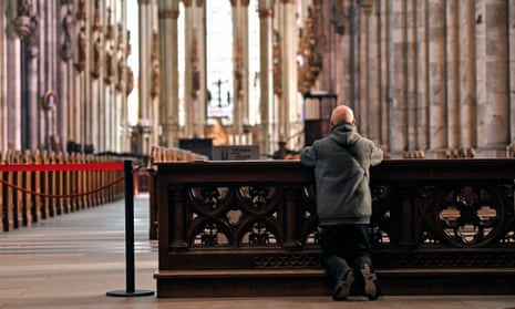 A man prays in Cologne Cathedral