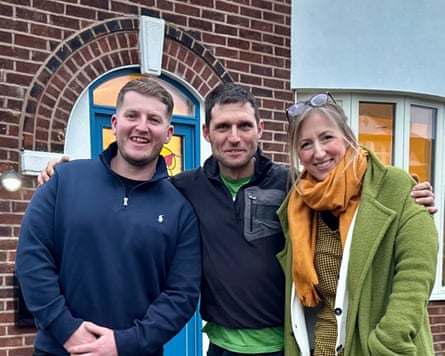 Guy with a couple in front of their home