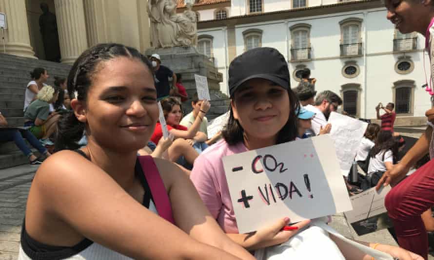 Thalita Alves, 20, left, and Gabriela Cunha, 18, from Federal Fluminense University demonstrate Friday on the steps of the state legislature in Rio de Janeiro.