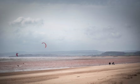 Walkers and kite surfers on Exmouth Beach