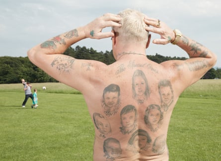 A man shows off tattoos of his children on a hot day in Dublin