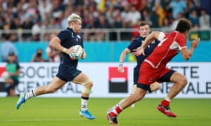 Darcy Graham of Scotland runs with the ball before passing it to George Horne of Scotland who goes on to score his team’s fourth try
