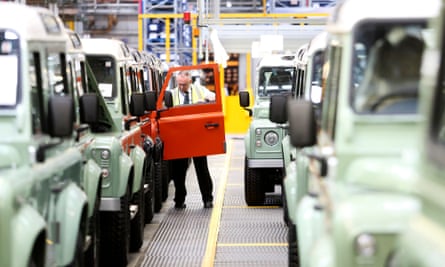 A worker performs quality control checks on Land Rover vehicles at the Tata Motors plant in Solihull, UK
