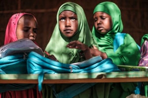 Children sit in a classroom at a school in the camp for internally displaced people of Farburo in Adlale