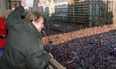 Vaclav Havel waves to thousands of demonstrators gathered on Prague’s Wenceslas Square, celebrating the communist capitulation and nomination of the new government formed by Marian Calfa, 10 December 1989.