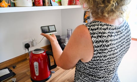 Woman with a British Gas smart meter in home kitchen.