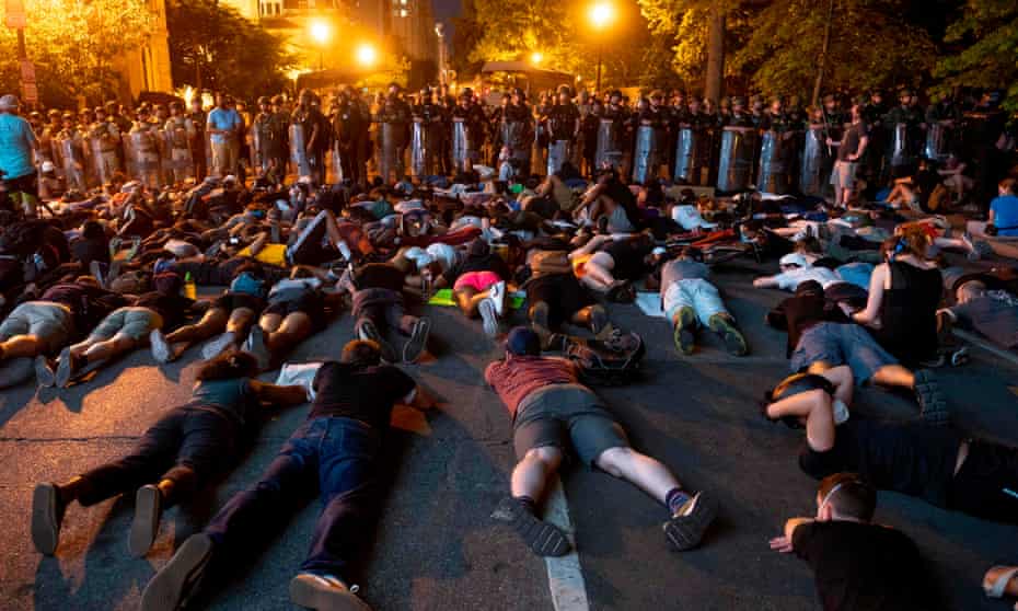 Demonstrators lie on the ground facing a police line in front of the White House during protests over the death of George Floyd in Washington DC on Wednesday.