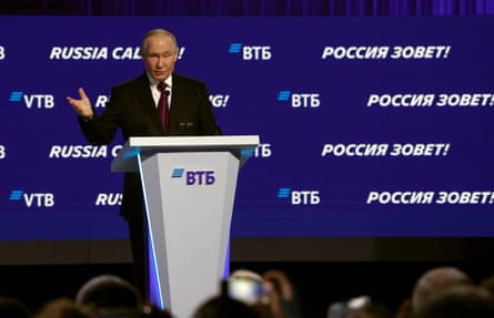 Putin speaking at a lectern