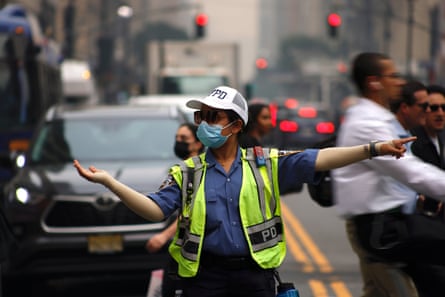 A policewoman directs traffic as air quality in New York City reached one of its worst levels in three years.