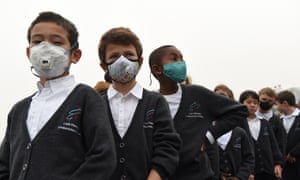 Children wear masks to protect against pollution at a school in Beijing. 