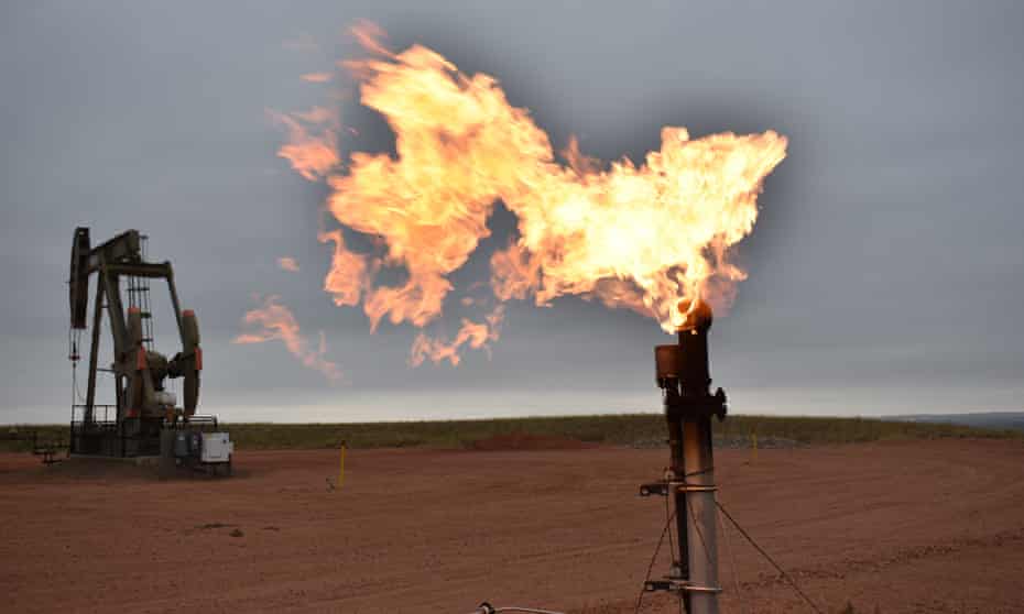 A flare burns natural gas at an oil well in Watford City, North Dakota. Gas is projected to cause 70% of the fossil CO2 emissions increase by 2030 under current policies.