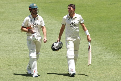 Mitchell Marsh and Pat Cummins walk off for lunch.