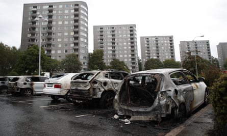 Burned-out cars at Frolunda Square in Gothenburg. Police suspect that gangs of youth were involved in the coordinated riots