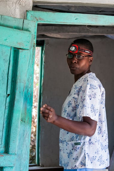 Marie Lerrecile Charles wears a headlamp to perform gynecological exams at a rural mobile clinic.