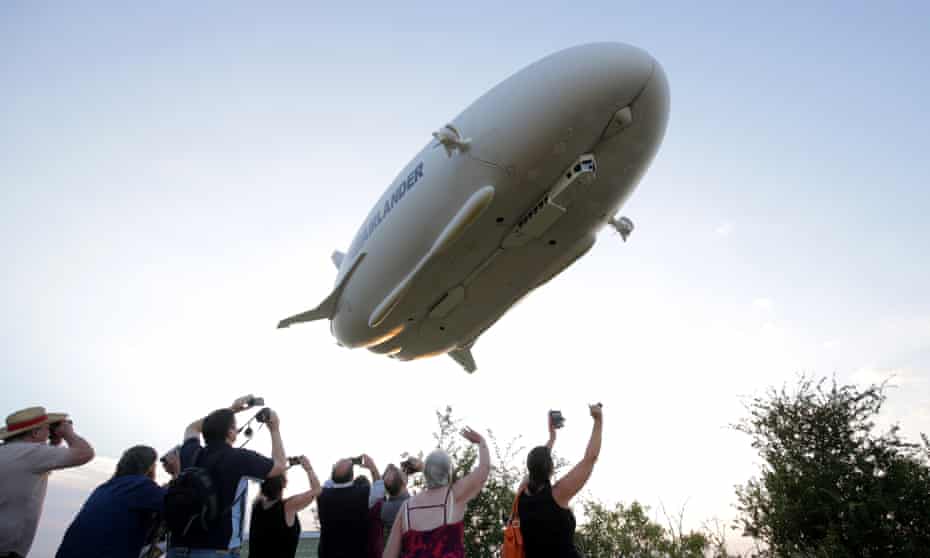 People watch as the Airlander 10 makes its maiden flight over Bedfordshire.