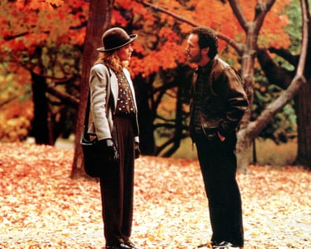 Meg Ryan and Billy Crystal in a park with autumn colours.