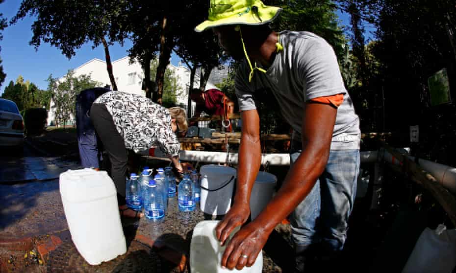 Residents of Cape Town collect drinking water from a mountain spring collection point