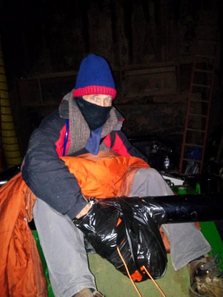 a man sits with his hands duct-taped together