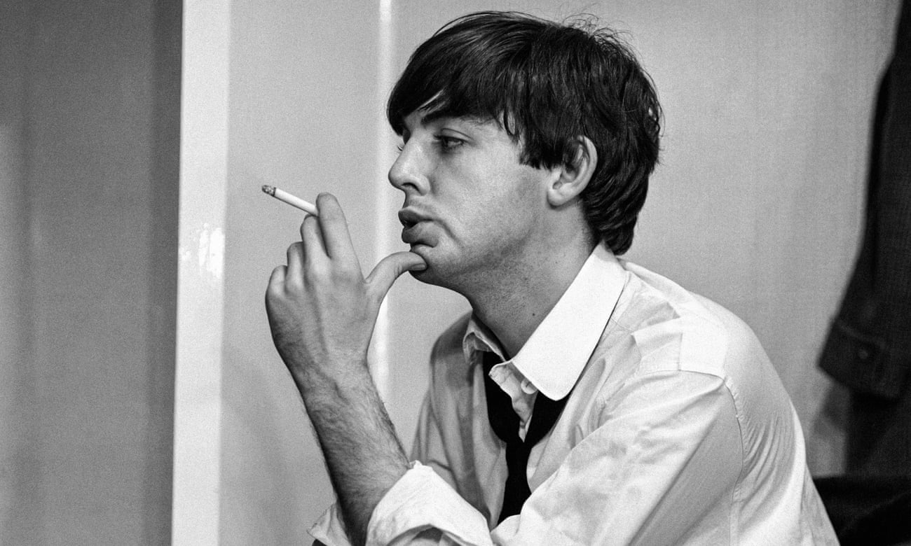 McCartney (seen in profile, in black and white image) wears shirt and tie, and smokes a cigarette