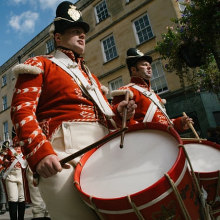 A marching soldier with a large drum