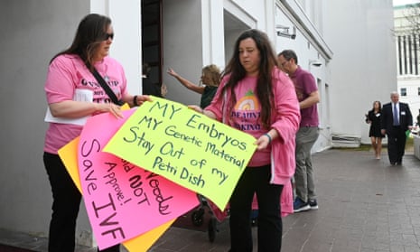 people hold signs in support of IVF