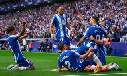 The Espanyol players mob Joselu after the former Stoke and Newcastle striker’s penalty added to Getafe’s woe.
