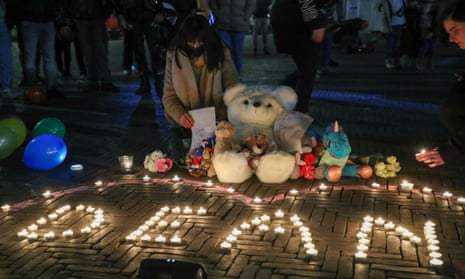 People put down candles and teddy bears at a silent gathering in tribute to four year old Dean Verberckmoes in front of Sint-Niklaas city hall, Belgium. 