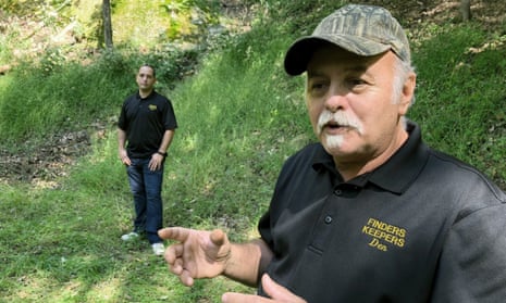 Dennis Parada, right, and his son stand at the site of the FBI's dig for cvil war-era gold in Dents Run, Pennsylvania, in September 2018. 