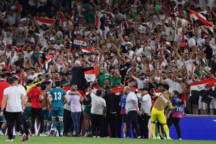 Iraq’s Australian coach Graham Arnold acknowledges the fans after the win.