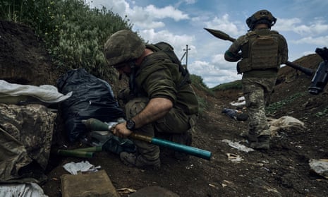 Ukrainian soldiers prepare to fire a rocket-propelled grenade at Russian positions near Bakhmut on Monday