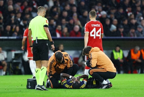 Bukayo Saka lies injured on the pitch as medical staff attend to him