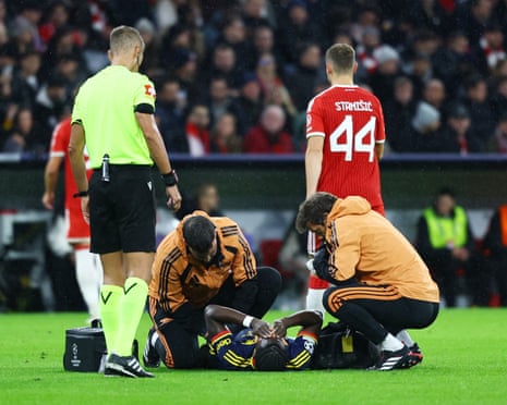 The Arsenal forward Bukayo Saka on the ground being treated by medical staff during his team's 2-2 Champions League draw at Bayern Munich.