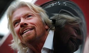 Sir Richard Branson leans out of the window of the drivers cab on board a Virgin Pendolino train at Lime Street Station in Liverpool