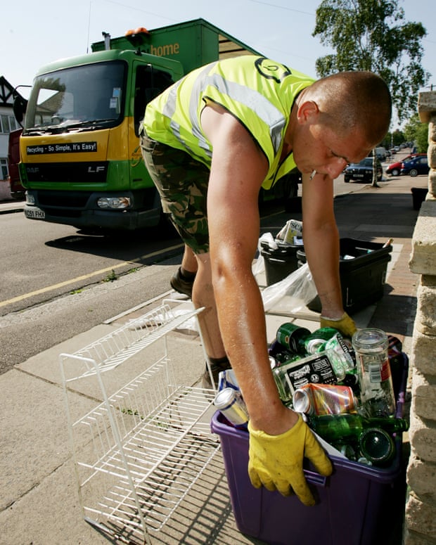 A member of the recycling team in Barnet, London, collects a box of cans and bottles