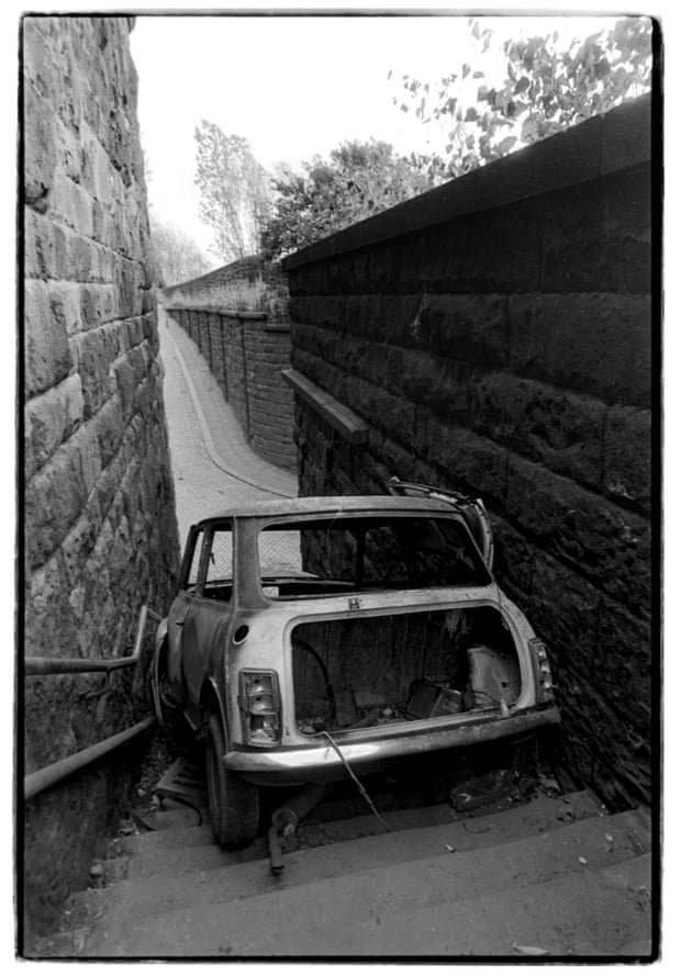 A burnt Mini on the steps of the former Scotswood station, 1990.